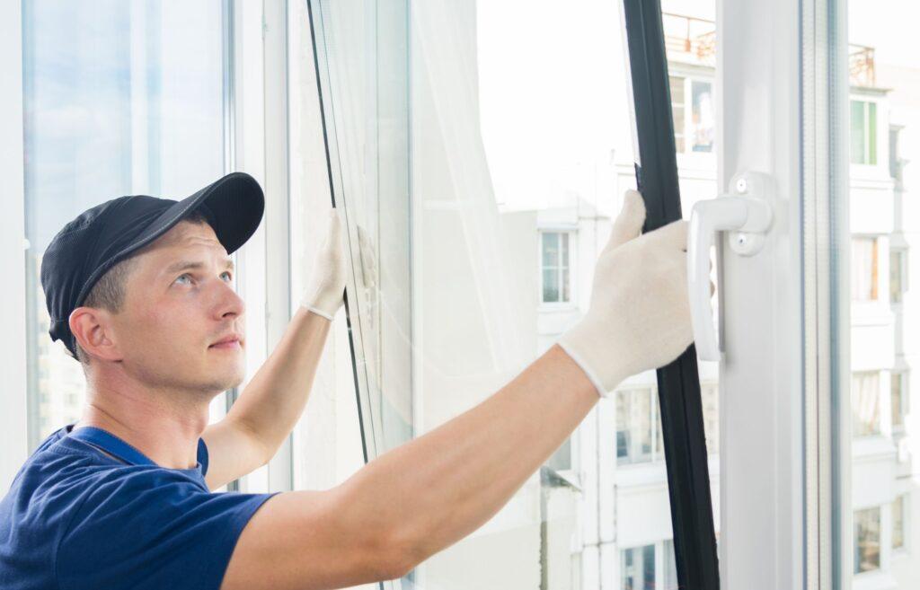Double glazing installer fitting a glazed window