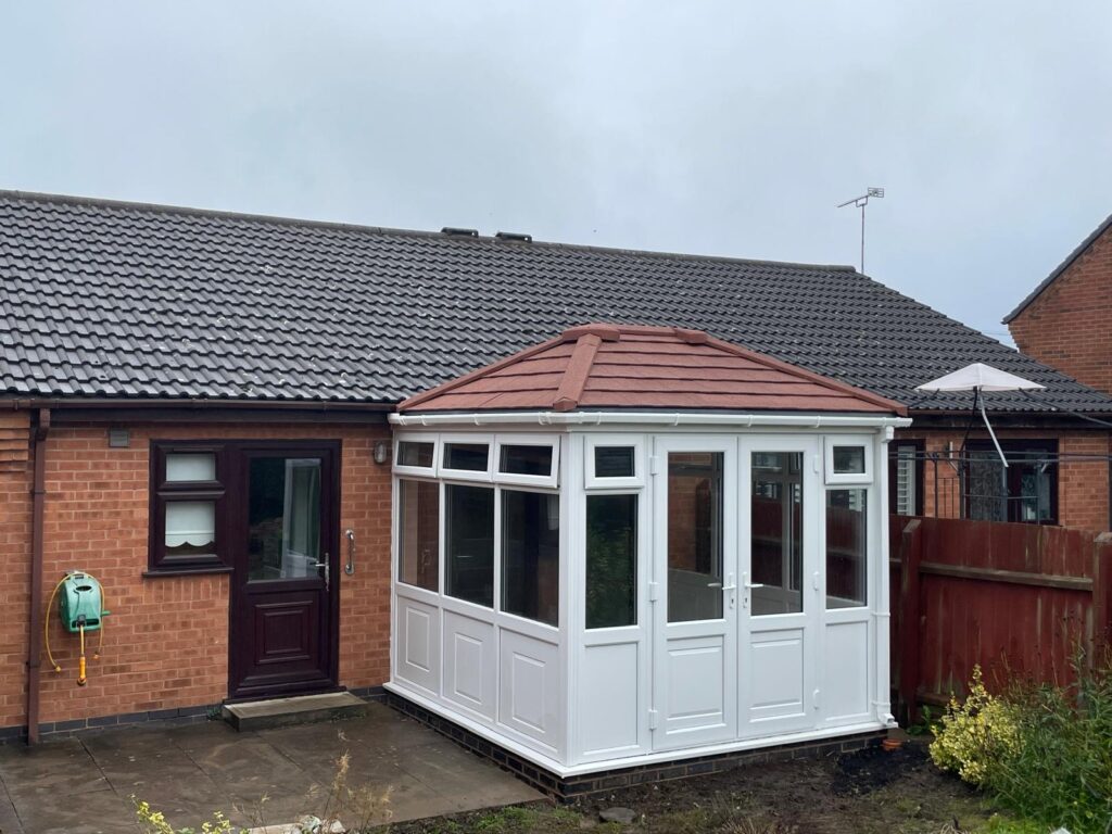 White uPVC conservatory installation 3m x 3m with warm roof, French doors and box gutter