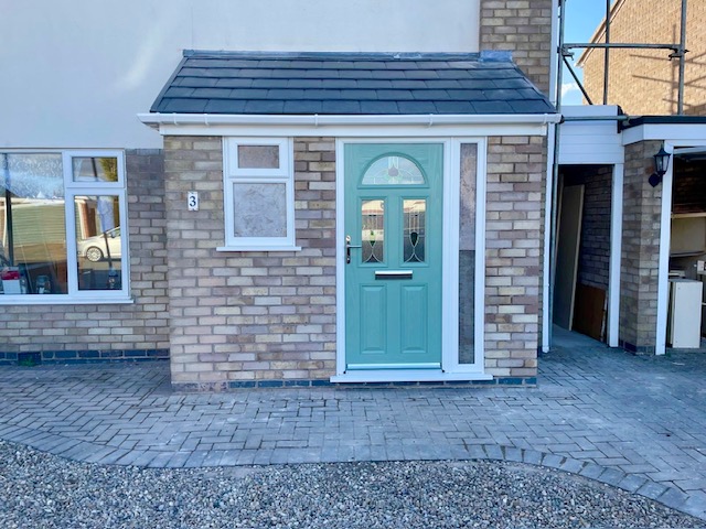 Brick porch renovation with Chartwell green door, uPVC window and pitched tiled roof in Leicester
