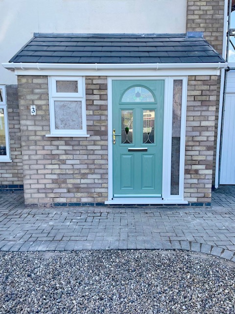 Brick porch renovation with Chartwell green door, uPVC window and tiled roof in Leicester