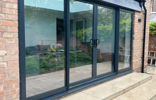 Anthracite-grey-aluminium-patio-doors-installation-scaled-1 Anthracite grey aluminium sliding patio doors on a home extension