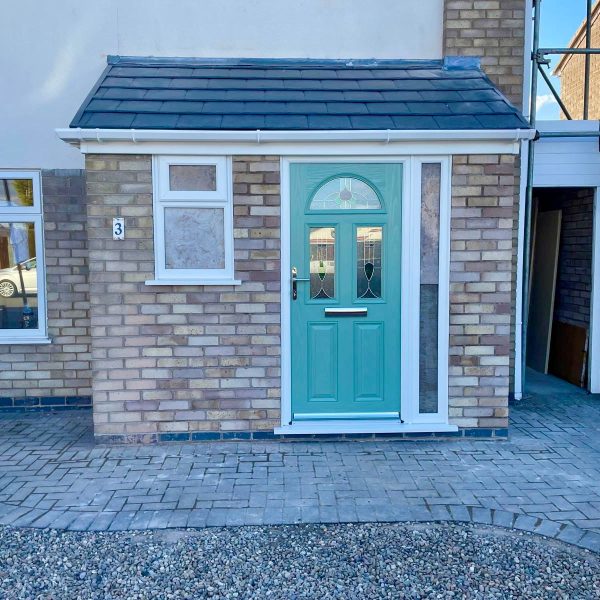 Brick porch installation with Chartwell green composite door, side panel, uPVC window and pitched tiled roof