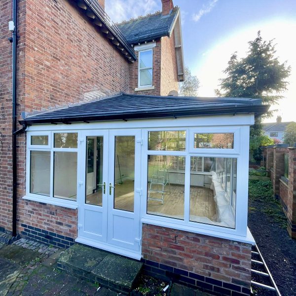 Conservatory installed with uPVC windows, French doors and solid tiled roof