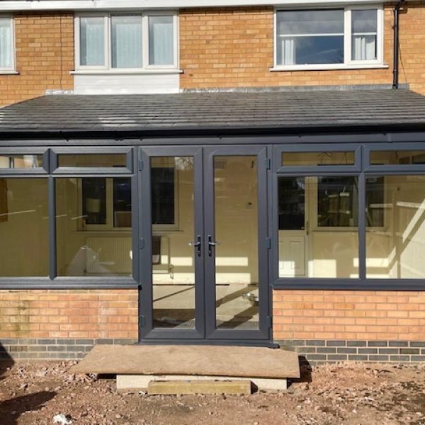 Lean to conservatory replacement in anthracite grey with a tiled warm roof added