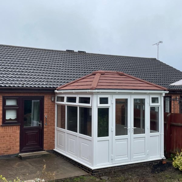 White uPVC conservatory installation 3m x 3m with warm roof, French doors and box gutter