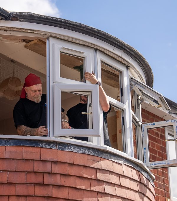 Window fitters installing bay window