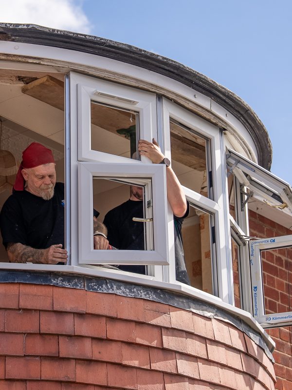 Window fitters installing double glazed bay window in Leicester